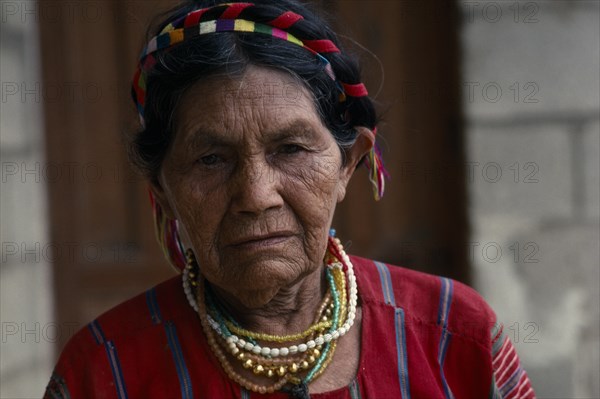 GUATEMALA, San Antonio de Palopo, "Head and shoulders portrait of elderly Cakchiquel Maya woman wearing traditional dress, hair braids and jewellery. "