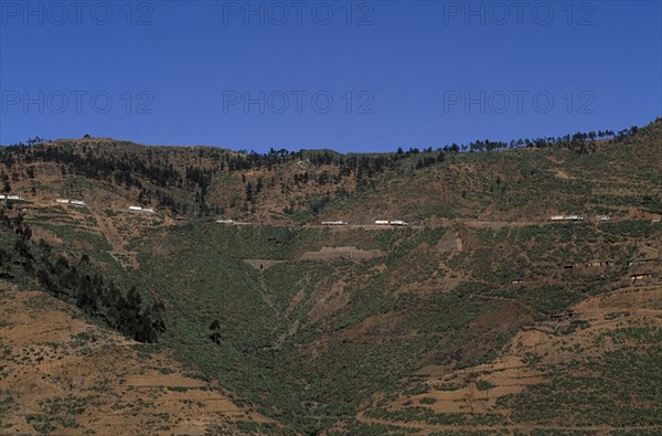 ERITREA, Aid, Distant view towards UN relief convoy of World Food Programme trucks on high Asmara - Massawa road.