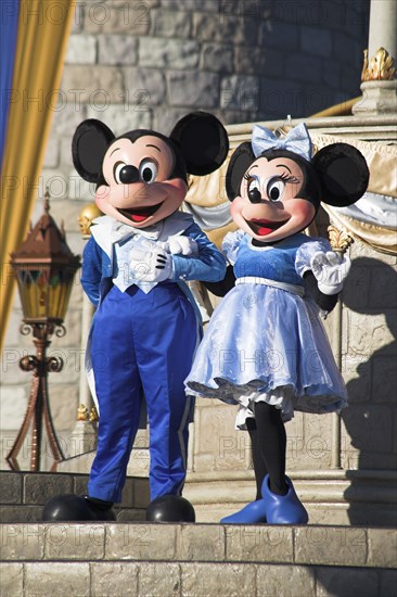 USA, Florida, Orlando, Walt Disney World Resort. Mickey and Minnie Mouse characters on stage in the Magic Kingdom.