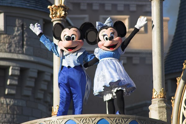 USA, Florida, Orlando, Walt Disney World Resort. Mickey and Minnie Mouse characters on stage in the Magic Kingdom.