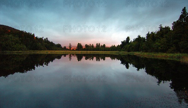 NEW ZEALAND, SOUTH ISLAND, WEST COAST, "LAKE MATHESON, DUSK LOOKING EAST ACROSS LAKE MATHESON TOWARDS FOX GLACIER."