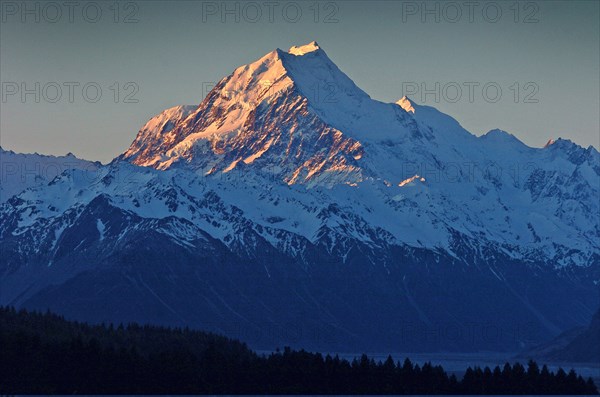 NEW ZEALAND, SOUTH ISLAND, WEST COAST, "MOUNT COOK NATIONAL PARK, VIEW OF NEW ZEALANDS HIGHEST MOUNTAIN MOUNT COOK WITH EVENING SUN ON ITS WEST FACE TAKEN FROM ROUTE 80 MOUNT COOK ROAD."