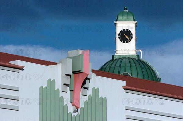 NEW ZEALAND, NORTH ISLAND, HAWKES BAY, "NAPIER, ART DECO STYLE FACADE OF THE MASONIC HOTEL ON MARINE PARADE WITH THE DOOM AND CLOCK TOWER OF THE A&B BUILDING BEHIND. IN 1931 NAPIER WAS ALMOST COMPLETELY DESTOYED BY AN EARTHQUAKE. SUNSEQUENTLY THE TOWN NOW HAS ONE THE BEST PRESERVED COLLECTION OF ART DECO BUILDINGS IN THE WORLD"