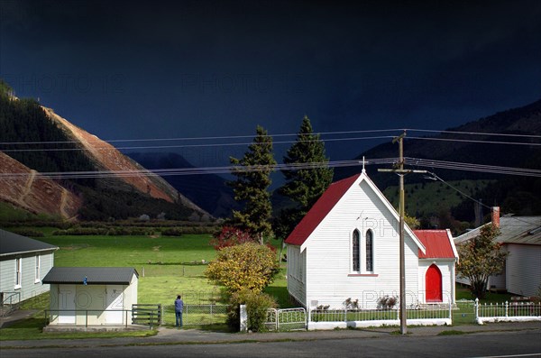 NEW ZEALAND, SOUTH ISLAND, CANVASTOWN, A STORM APPROACHES THE LOCAL CHURCH AT CANVASTOWN VIEWED FROM ROUTE 6 PICTON TO NELSON ROAD.