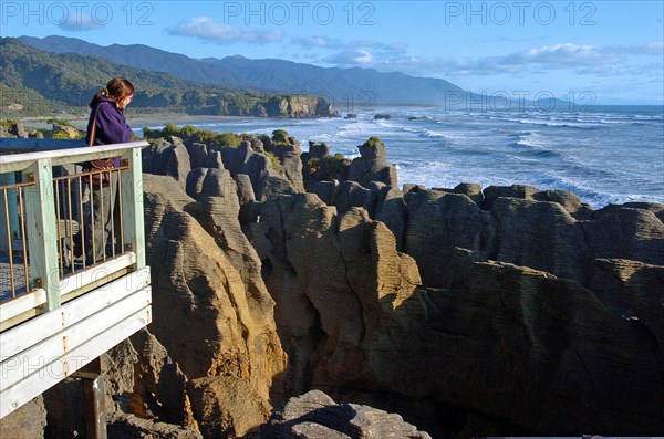 NEW ZEALAND, SOUTH ISLAND, PUNAKAIKI, "GEOLOGICAL FEATURED ROCKS CALLED THE PANCAKE ROCKS BLOWHOLES AT DOLOMITE POINT, PUNAKAIKI ON THE SOUTH ISLAND WEST COAST.THE ROCK HAS SPLIT INTO HORIZONTAL LAYERS TO RESEMBLE A TOWER OF PANCAKES."