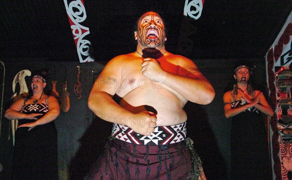 NEW ZEALAND, NORTH ISLAND , BAY OF PLENTY, "ROTORUA, THE HARKA WAR DANCE PERFORMED BY MAORI AT THE TAMAKI MAORI VILLAGE PERFORMED IN THE WHENUAI OR BIG HOUSE 15 MILE SOUTH OF ROTORUA."