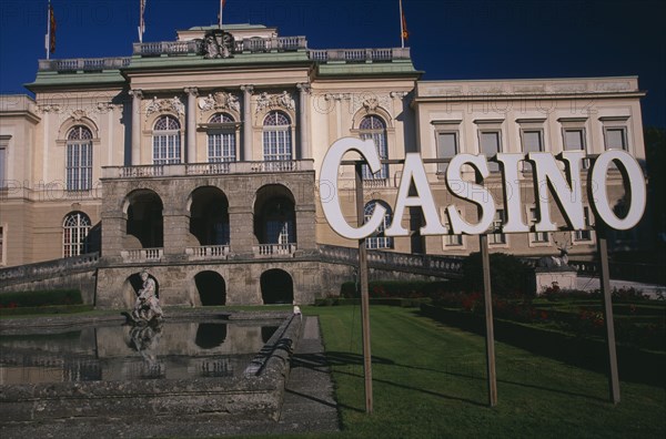 AUSTRIA, Salzburg, "Klessheim Palace, now the Salzburg Casino.  Baroque exterior dating from 18th c. and designed by architect Fischer von Erlach.  Lake, statue and sign for Casino.  "