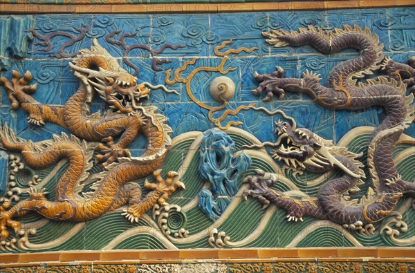 CHINA, Beijing, "Beihai Park.  Detail of Nine Dragon Screen constructed from coloured, glazed tiles and originally used to give protection from evil spirits to temple (now disappeared)."