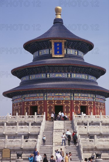 CHINA, Beijing, "Tiantan Park.  The Hall of prayer for Good Harvests ( qi nian dian ).  Tiered, highly decorated exterior with visitors on steps in foreground. "