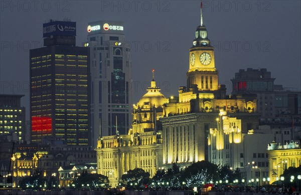 CHINA, Shanghai, The Bund at night with skyscrapers and the Customs House illuminated.