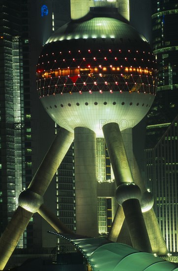 CHINA, Shanghai, Part view of the Oriental Pearl Tower exterior illuminated at night.