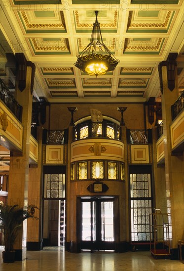 CHINA, Shanghai, "Peace Hotel.  Interior of foyer with marble floor, upper balcony and revolving door at entrance."