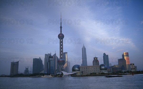 CHINA, Shanghai, Pudong skyline at dusk with skyscrapers including the Oriental Pearl Tower and the Jin Mao Building.