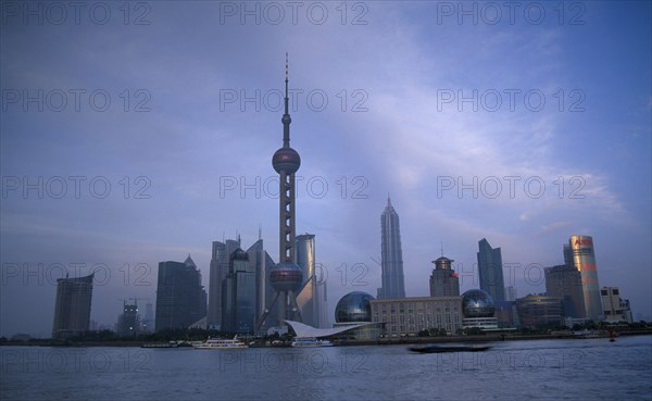 CHINA, Shanghai, Pudong skyline at dusk with skyscrapers including the Oriental Pearl Tower and the Jin Mao Building.