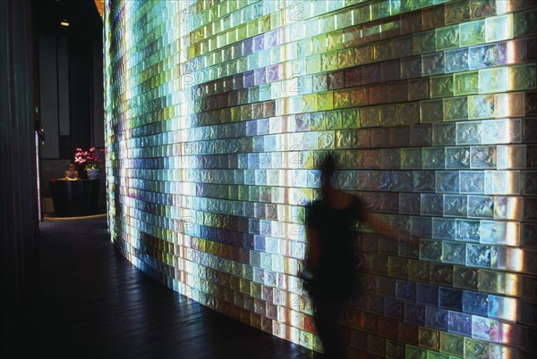 CHINA, Shanghai, Iridescent tiled entrance to the Liuli China Museum near Xintiandi with figure of visitor blurred in movement in the foreground.