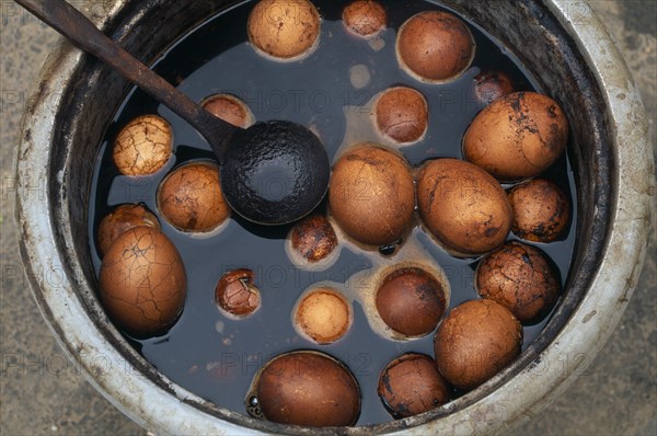 CHINA, Beijing, Pickled eggs in bowl with ladle.