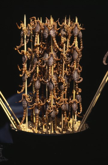 CHINA, Beijing, Barbequed scorpions on bamboo skewers.