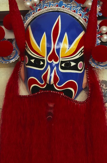 CHINA, Beijing, "Huguang Guildhall.  Bright red, blue, yellow and black opera mask."