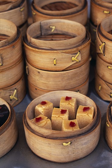 CHINA, Beijing, Donghua Yeshi food market.  Display of bamboo steamers of sweetmeats.