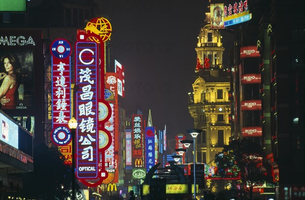 CHINA, Shanghai, Nanjing Lu.  Street scene at night with mass of illuminated neon signs and advertising.