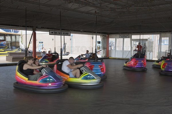 ENGLAND, West Sussex, Littlehampton, Families enjoying a Dodgem ride at Harbour Park Amusements