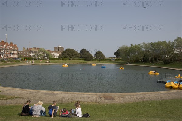 ENGLAND, West Sussex, Littlehampton, Families enjoying pedal boat rides at Oyster Pond Boating Lake