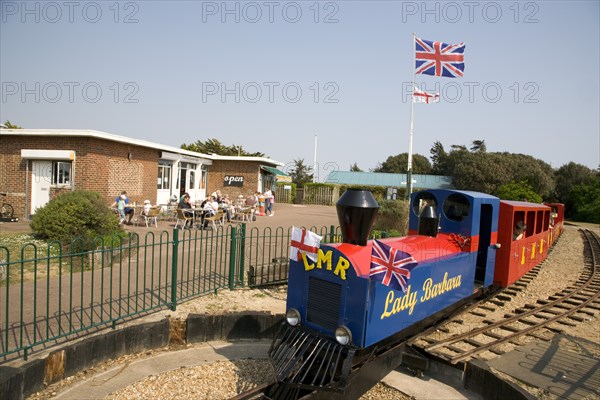 ENGLAND, West Sussex, Littlehampton, Families enjoying the Miniature Railway train ride at Norfolk Gardens. Union Jack Flag flying