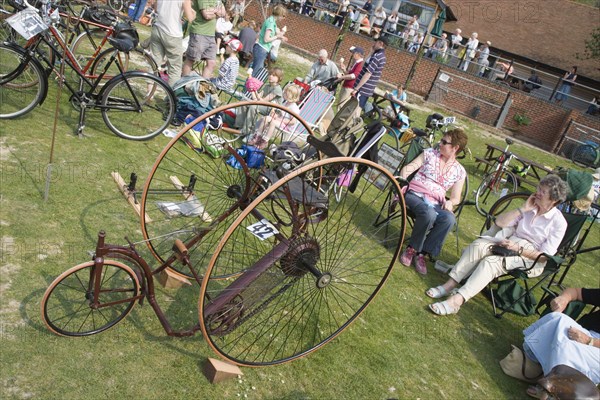 ENGLAND, West Sussex, Amberley, Amberley Working Museum. Veteran Cycle Day with visitors looking at displays of bicycles showing the development of cycle design through the ages