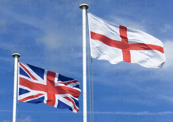 ENGLAND, West Sussex, Littlehampton, Flagpoles with the English flag of Saint George on the right with the Union Flag or Union Jack of Great Britain on the left
