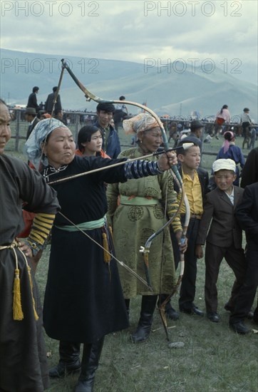 MONGOLIA, Ulan Bator, Nadam  National Day Ulan Bator Stadium Woman competitor taking part in national archery competition. Ulaanbaatar East Asia Asian Baator Female Woman Girl Lady Mongol Uls Mongolian Ulaan