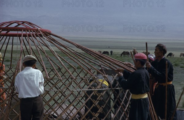 MONGOLIA, Gobi Desert, Bigersum  Freedom negdel collective  Khalkha herdsmen building a ger or yurt on summer grassland pastures.  First erecting the frame. Khalha East Asia Asian Mongol Uls Mongolian