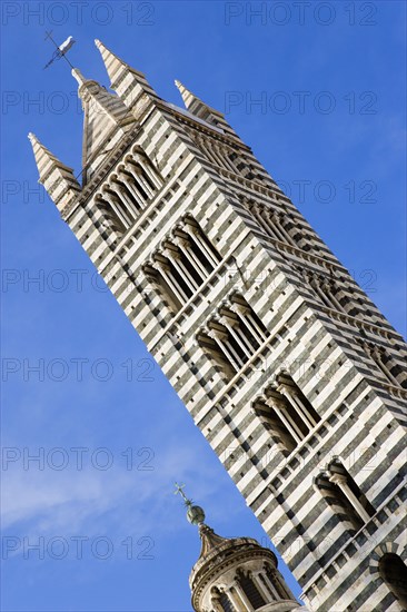 ITALY, Tuscany, Siena, The belltower of the Gothic Duomo or Cathedral of Santa Maria Assunta made from local white and greenish black marble. Black and white are the colours of the city.