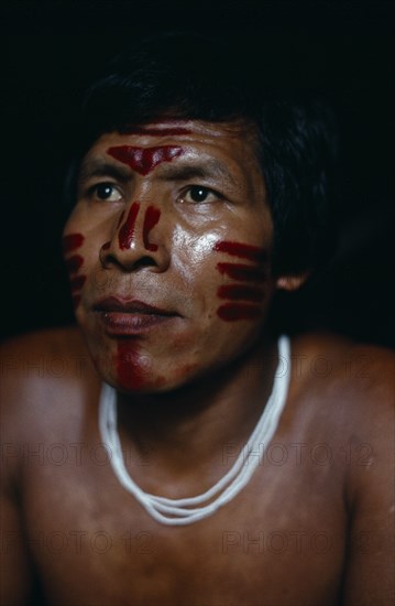 COLOMBIA, North West Amazon Vaupes rio Piraparana, Tukano Indigenous People, Head and shoulders portrait of Venancio Makuna  Ignacio's son  with ceremonial dark red Achiote facial paint. Tukano Makuna Indian North Western Amazonia American Colombian Columbia Hispanic Indegent Latin America Latino Male Men Guy South America Tukano Vaupes