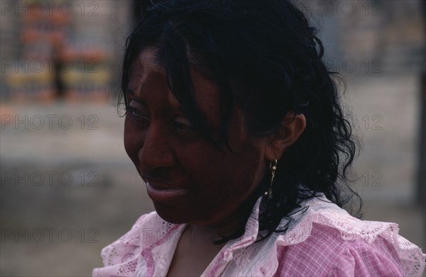 COLOMBIA, Guajira Peninsula, Guajiro Indians, Head and shoulders portrait of Guajira woman with face painted dark red (Achiote fruit) and black with a mixture of goat's fat and charcoal as protection against sun and strong sea winds. Wayu Wayuu Guajiro Amerindian Arawakan Colombia-Venezuela border