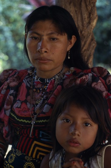COLOMBIA, Darien, Kuna Indians, Portrait of Kuna mother and young daughter wearing brightly coloured blouses and typical Kuna mola  applique patchwork layered design  from Arquia community in Darien. Cuna Kuna