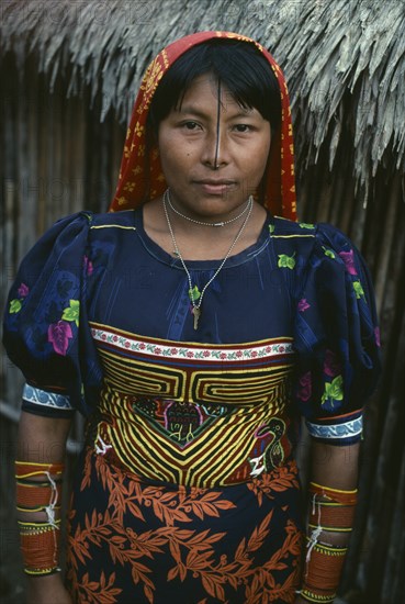 PANAMA, San Blas Islands Ustupu, Kuna Indians, Kuna woman wearing traditional mola with fine layered applique design  black line drawn from forehead along length of nose  typical coloured bead amulets  Cuna Caribbean American Central America Classic Classical Female Women Girl Lady Hispanic Historical Jewelry Latin America Latino Older Panamanian West Indies