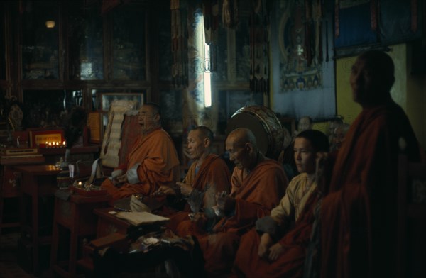 MONGOLIA, Ulan Bator, "Ulan Bator Buddhist temple, the only one the Russian dominated Mongol government allowed to exist and be used for worship (in 1970's) Buddhist monks praying in low natural light. "