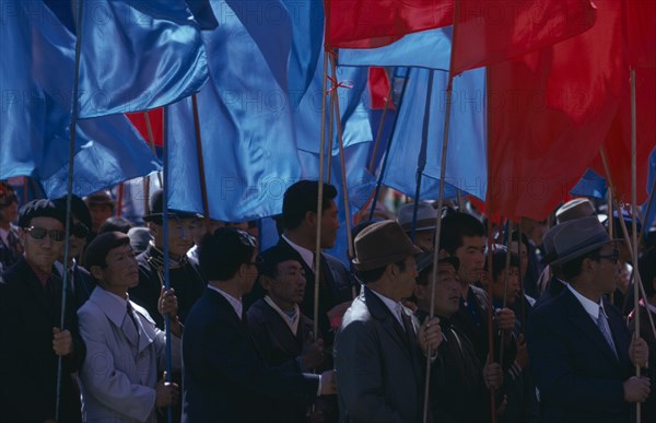 MONGOLIA, Ulan Bator, "Nadam  National Day Parade of workers and party members carrying red and blue banners, the two prime national colours.  Ulaan Baatar  Soviet Mongolia East Asia Asian Baator Male Man Guy Mongol Uls Mongolian "