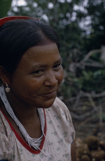 COLOMBIA, North West Amazon, Tukano Indigenous People, "Head and shoulders portrait of Barasana woman  Paulina, Bosco's sister  wearing multi-strand white glass bead necklace and silver ear-rings. Tukano sedentary Indian tribe North Western Amazonia American Colombian Columbia Female Women Girl Lady Hispanic Indegent Latin America Latino South America Tukano "