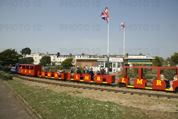 ENGLAND, West Sussex, Littlehampton, Families enjoying the Miniature Railway train ride at Norfolk Gardens.