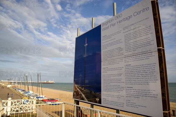 ENGLAND, East Sussex, Brighton, Ruins of the West pier with boards showing plans for the i360 observation tower top be built.