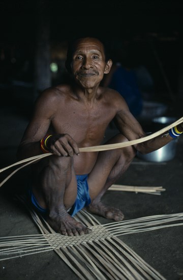 COLOMBIA, North West Amazon, Tukano Indigenous People, Makuna head man Ignacio starting to make a woven cane basket. Tukano  Makuna Indian North Western Amazonia American Colombian Columbia Hispanic Indegent Latin America Latino Male Men Guy South America Tukano