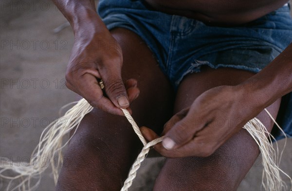 COLOMBIA, North West Amazon, Tukano Indigenous People, Close-up of Makuna man making cumare palm fibre rope. Tukano  Makuna Indian North Western Amazonia American Colombian Columbia Fiber Hispanic Indegent Latin America Latino Male Men Guy South America Tukano