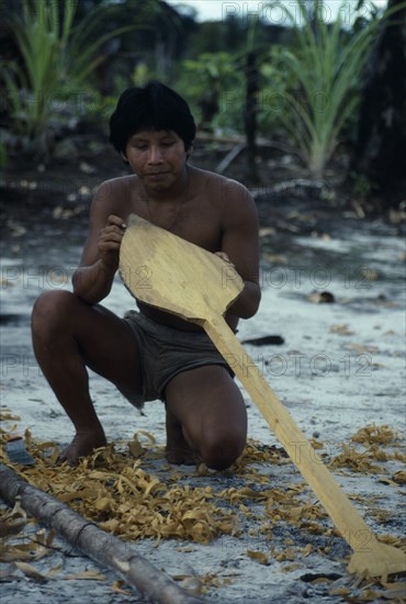 COLOMBIA, North West Amazon, Tukano Indigenous People, Makuna man making a typical Vaupes canoe paddle  short and broad blade to assist paddling through fast and dangerous rapids. Tukano  Makuna Indian North Western Amazonia American Colombian Columbia Hispanic Indegent Latin America Latino Male Men Guy South America Tukano