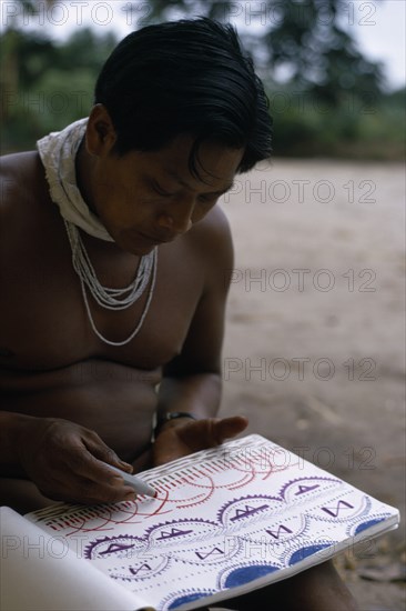 COLOMBIA, North West Amazon, Tukano Indigenous People, Young Barasana shaman Pacico draws for anthropologist Stephen Hugh-Jones the colour visions he sees when under the influence of hallucinogenic drug Yage. Tukano sedentary Indian tribe North Western Amazonia Western influence American Colombian Colored Columbia Hispanic Indegent Latin America Latino South America Tukano Turkano One individual Solo Lone Solitary