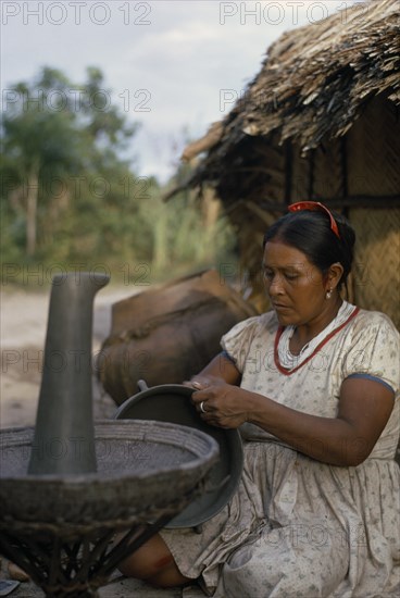 COLOMBIA, North West Amazon, Tukano Indigenous People, Barasana woman  Paulina  headman Bosco's sister  making clay cooking pot. Note the larger fired pot behind her. A fine potter whose death has marked the virtual extinction of pottery-making amongst the Barasana   Tukano sedentary Indian tribe North Western Amazonia American Colombian Columbia Female Women Girl Lady Hispanic Indegent Latin America Latino South America Tukano Female Woman Girl Lady One individual Solo Lone Solitary