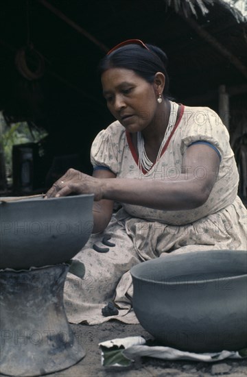 COLOMBIA, North West Amazon, Tukano Indigenous People, Barasana woman Paulina making clay cooking pot from grey river clay. Tukano sedentary Indian tribe North Western Amazonia American Colombian Columbia Female Women Girl Lady Hispanic Indegent Latin America Latino South America Tukano  Female Woman Girl Lady One individual Solo Lone Solitary