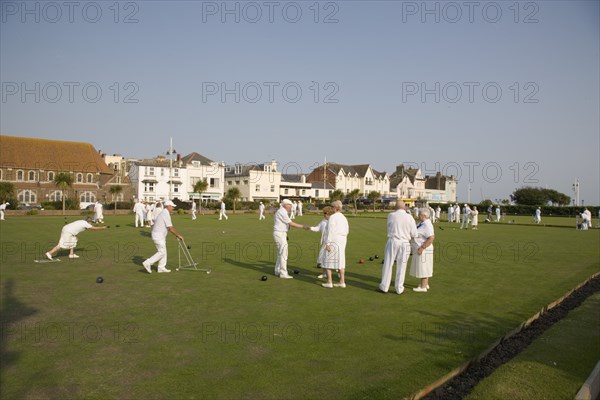 ENGLAND, West Sussex, Bognor Regis, Men and women playing a game of bowls on beach front green