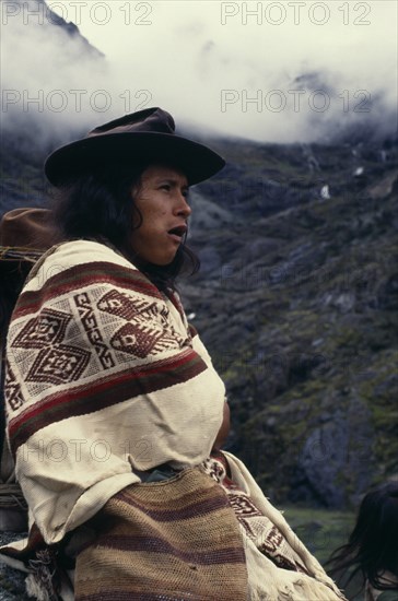 COLOMBIA, Sierra Nevada de Santa Marta, Ika, Portrait of Ika shepherd wrapped in woven wool&cotton manta cloak  high in Sierra Nevada de Santa Marta. Arhuaco Aruaco indigenous tribe American Colombian Colombia Hispanic Indegent Latin America Latino South America  Arhuaco Aruaco indigenous tribe American Colombian Columbia Hispanic Indegent Latin America Latino South America Farming Agraian Agricultural Growing Husbandry  Land Producing Raising One individual Solo Lone Solitary 1 Agriculture Single unitary