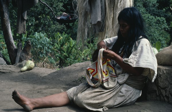 COLOMBIA, Sierra Nevada de Santa Marta, Ika, Ika woman in traditional wool&cotton manta cloak sewing a coloured wool mochila shoulder bag in which men and women carry personal belongings. Arhuaco Aruaco indigenous tribe American Classic Classical Colombian Colombia Female Women Girl Lady Hispanic Historical Indegent Kids Latin America Latino Older South America  Arhuaco Aruaco indigenous tribe American Classic Classical Colombian Columbia Female Women Girl Lady Hispanic Historical Indegent Kids Latin America Latino Older South America Female Woman Girl Lady History One individual Solo Lone Solitary 1 Colored Male Man Guy Single unitary